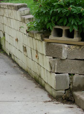 collapsing retaining wall with severe damage in Algona