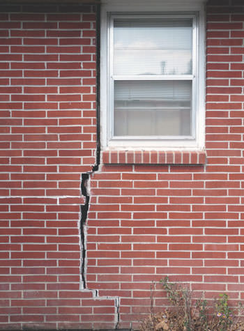 severe foundation wall cracks along a window in Osceola