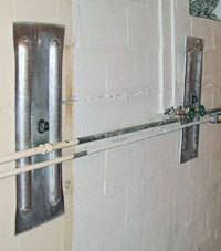 A foundation wall anchor system used to repair a basement wall in Algona