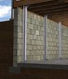 I-beam foundation wall supports installed in a Osage basement.
