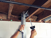 Straightening a foundation wall with the PowerBrace™ i-beam system in a Mason City home.