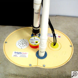 A sump pump system installed along a basement floor in Des Moines.